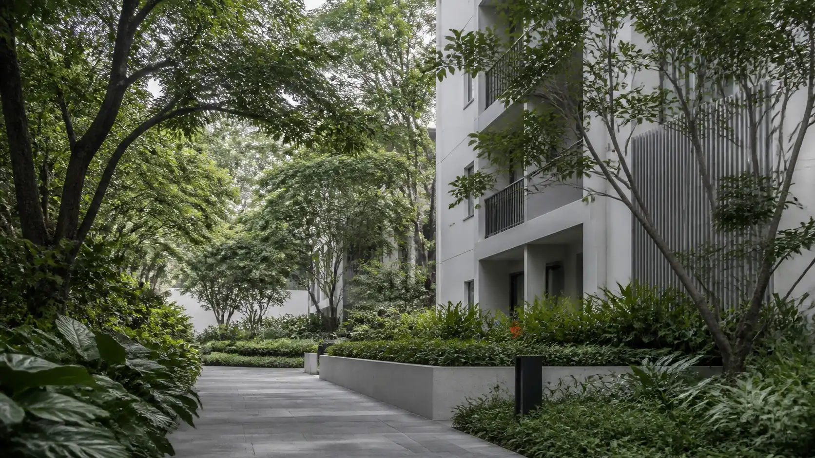 Landscaped contemporary apartment setting framed by mature trees